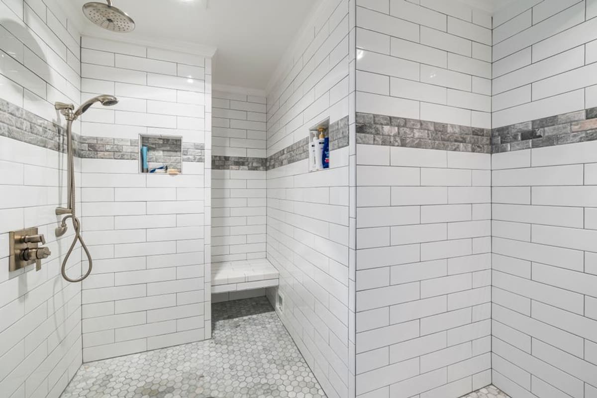 A walk-in shower with a low threshold and a built-in seat